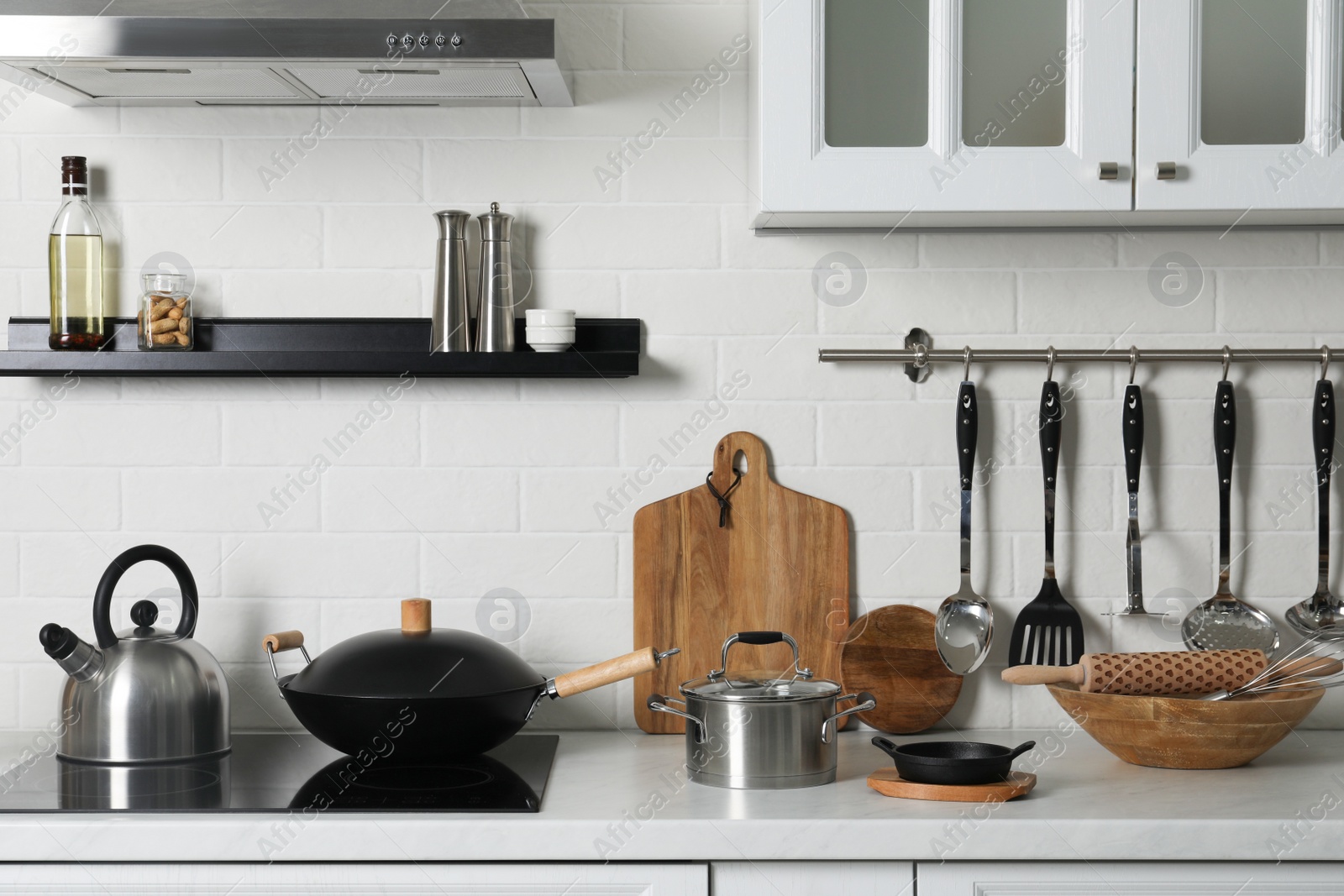 Photo of Countertop with different cooking utensils in kitchen