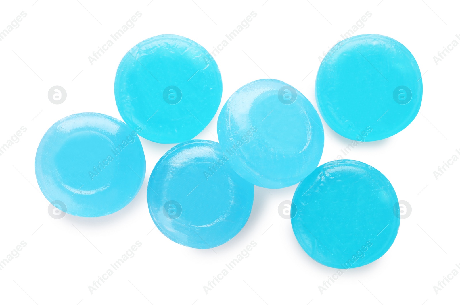 Photo of Many light blue cough drops on white background, top view