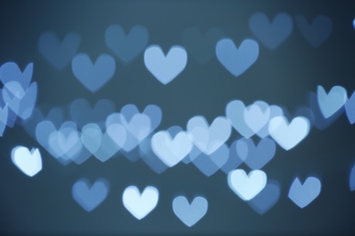 Photo of Blurred view of beautiful heart shaped lights on gray background