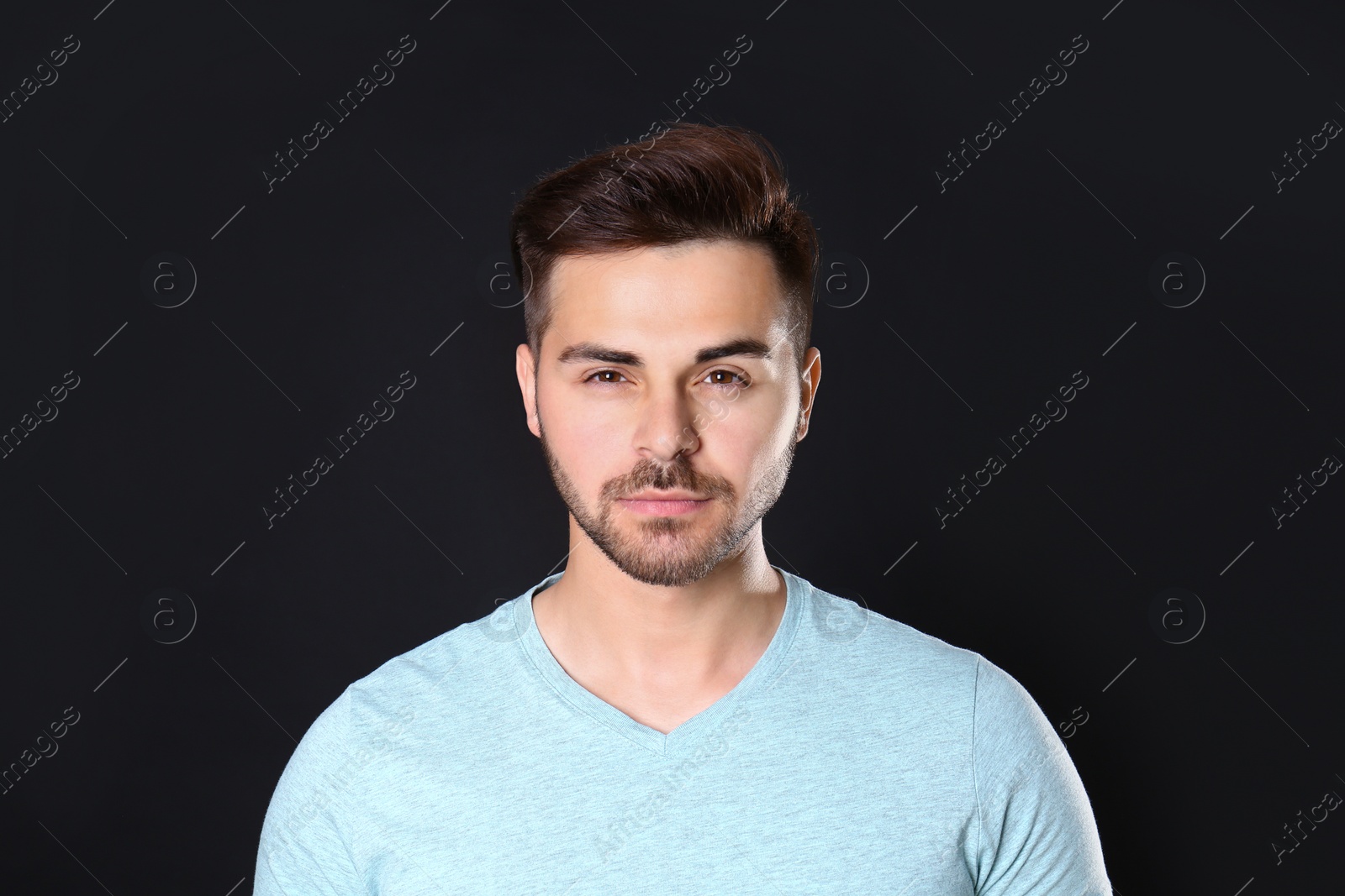 Photo of Portrait of handsome man on black background