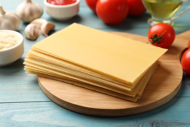 Photo of Ingredients for lasagna on blue wooden table, closeup