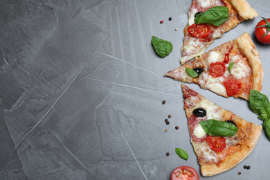 Photo of Pieces of delicious pizza Diablo on grey table, flat lay. Space for text