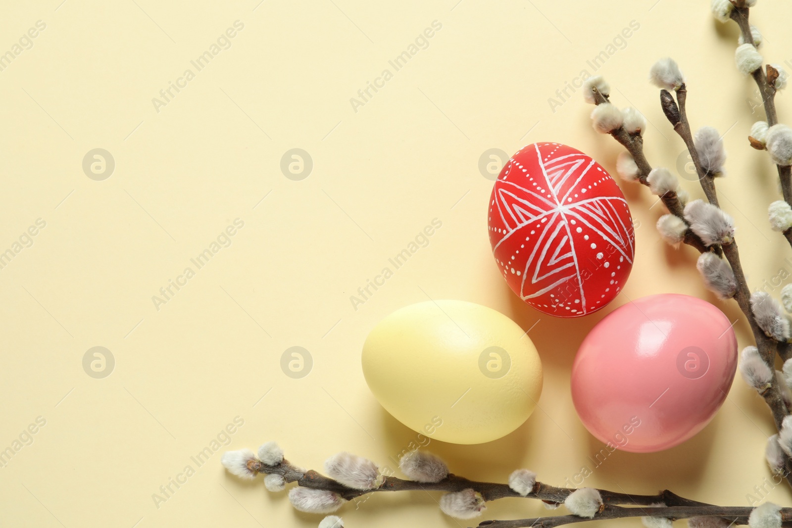 Photo of Flat lay composition with painted Easter eggs on color background, space for text