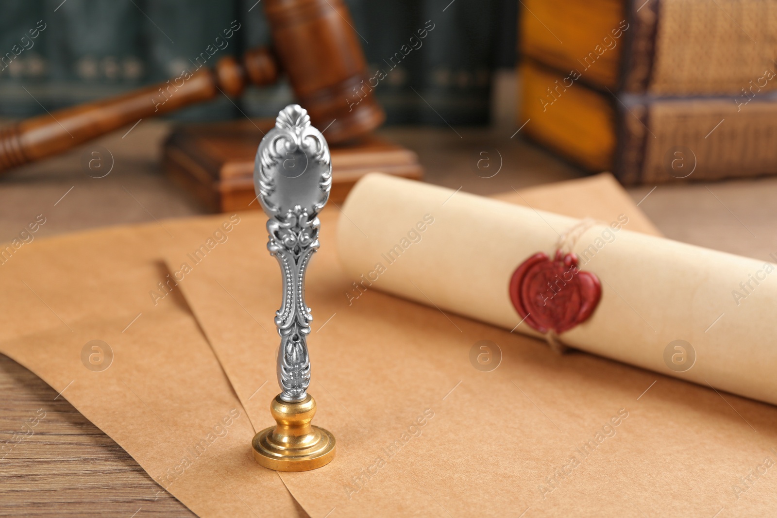 Photo of Notary's public pen and document with wax stamp on wooden table