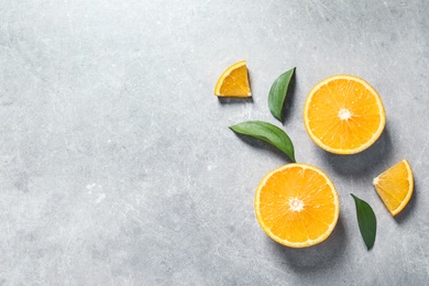 Photo of Flat lay composition with fresh oranges on grey background. Space for text