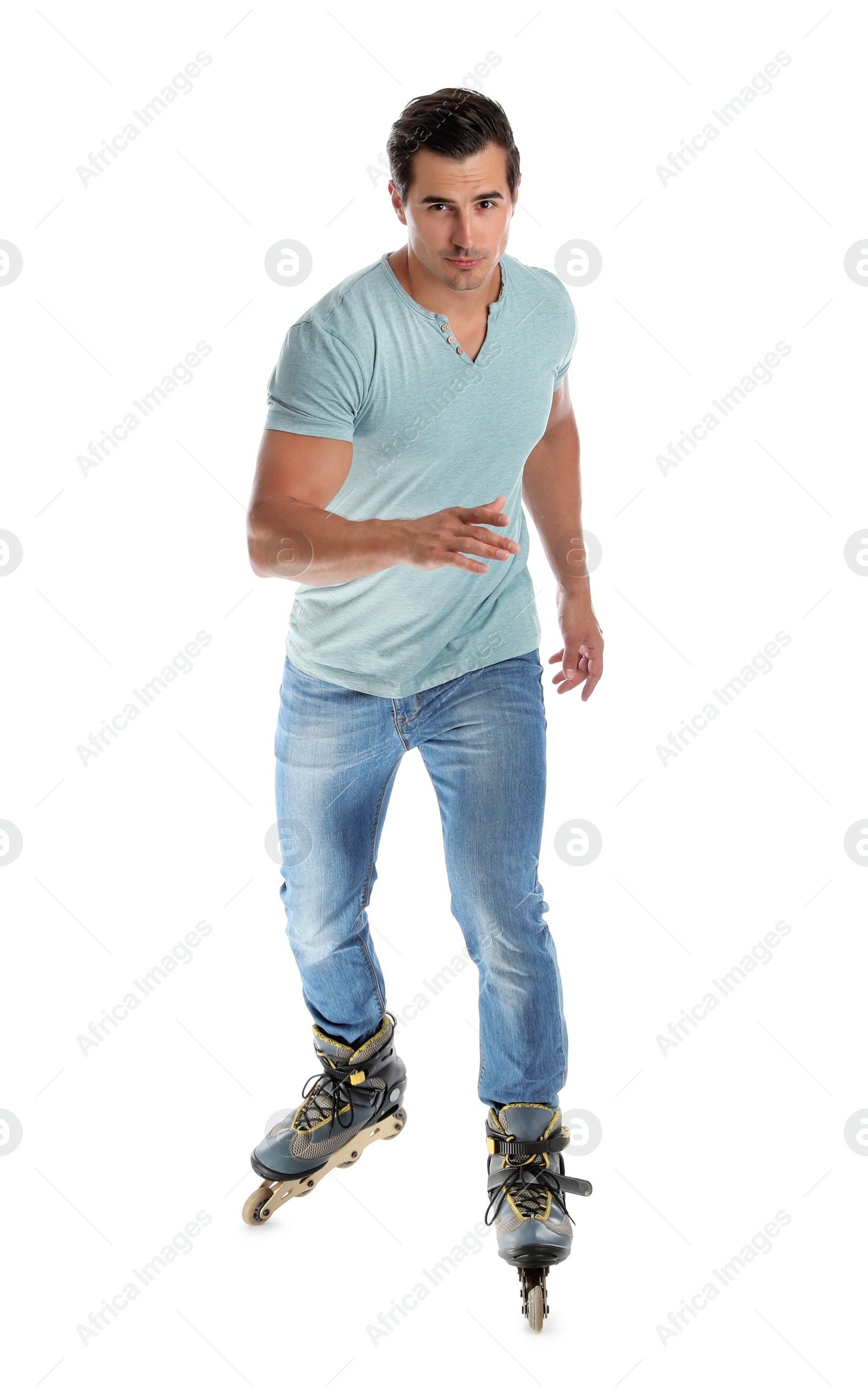 Photo of Handsome young man with inline roller skates on white background