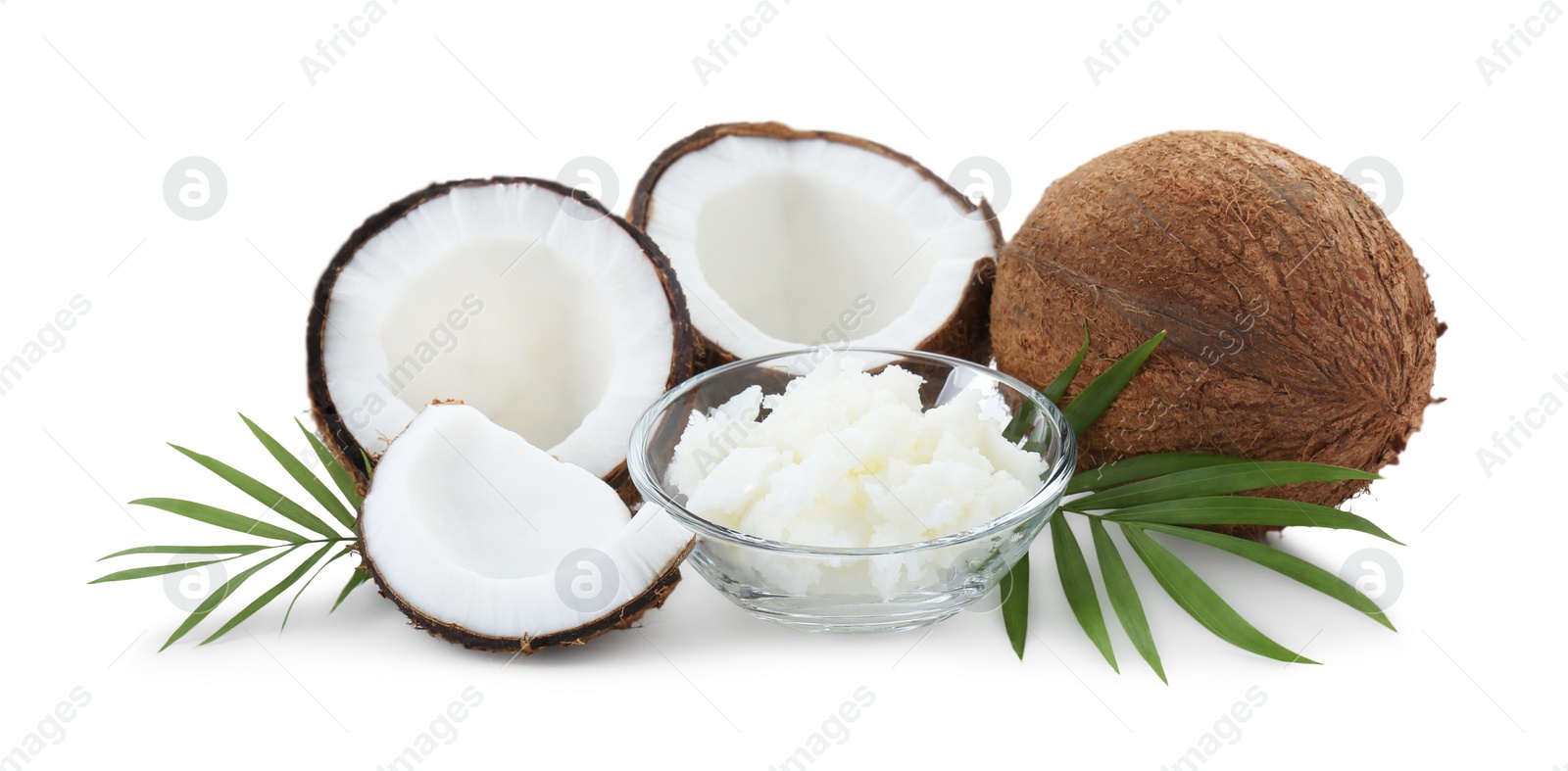 Photo of Organic coconut cooking oil, fresh fruits and leaves isolated on white