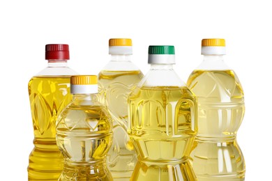 Photo of Bottles of cooking oil on white background