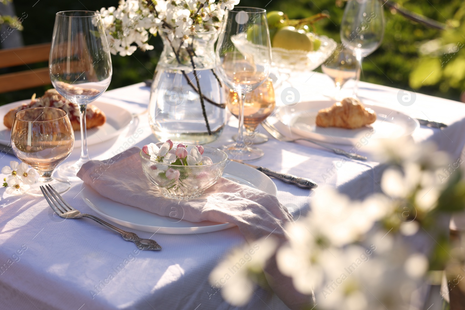 Photo of Stylish table setting with beautiful spring flowers in garden