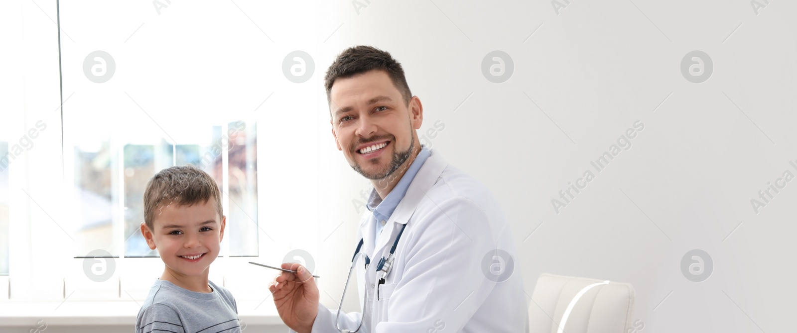 Image of Doctor working with little patient in clinic, space for text. Banner design