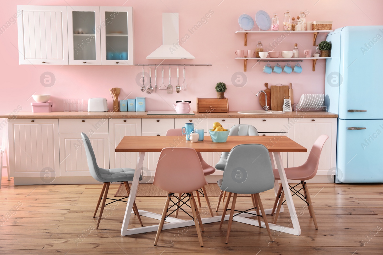 Photo of Stylish kitchen interior with dining table and chairs