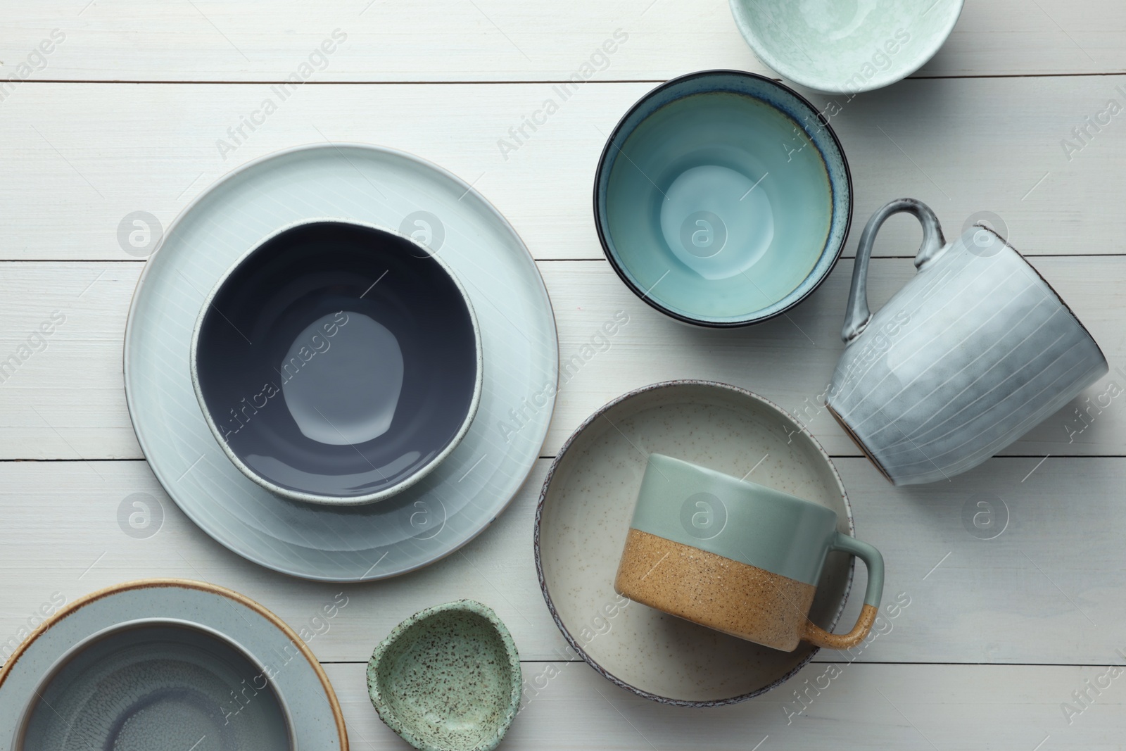 Photo of Stylish empty dishware on white wooden table, flat lay