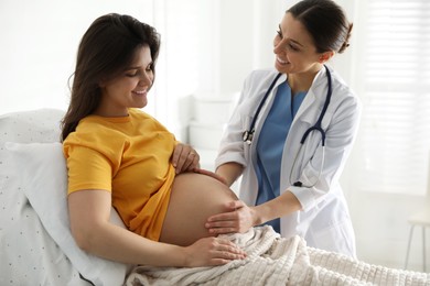 Doctor examining woman before giving child birth in maternity hospital