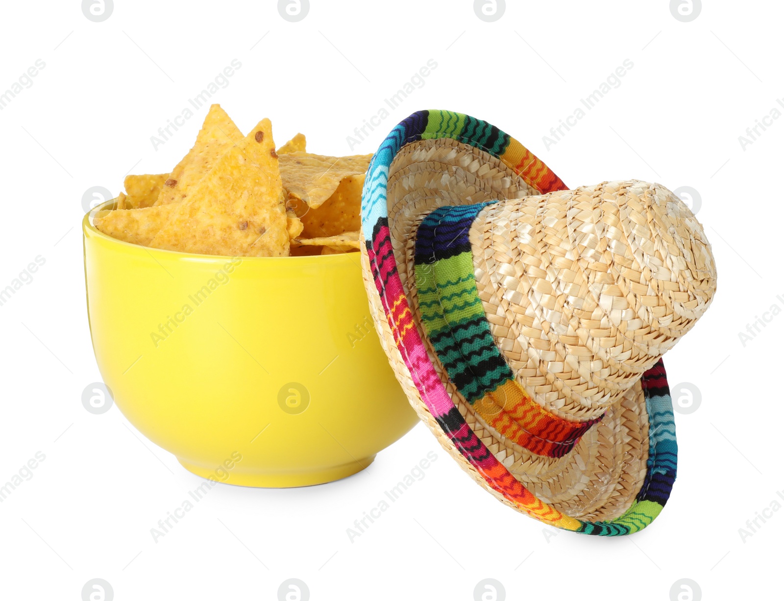 Photo of Mexican sombrero hat and nachos chips in bowl isolated on white