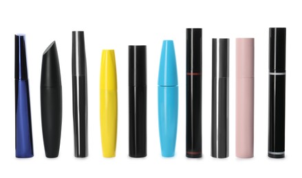 Photo of Many mascaras for eyelashes on white background. Makeup product