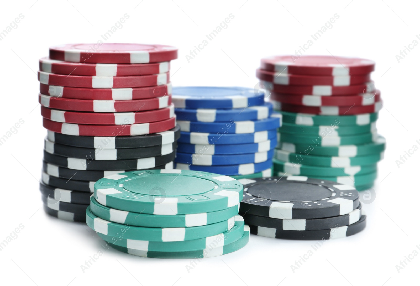 Photo of Plastic casino chips stacked on white background. Poker game