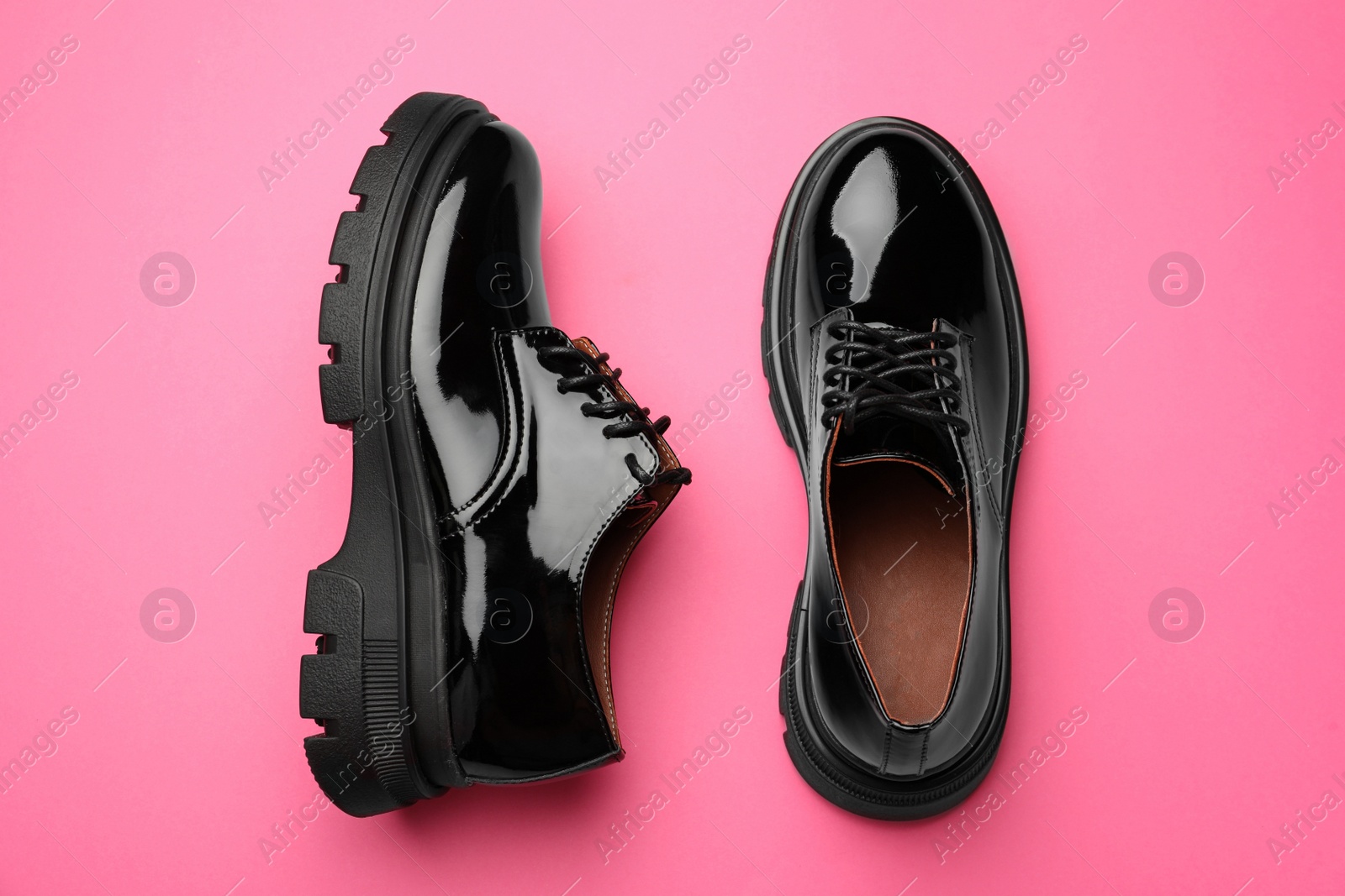 Photo of Pair of stylish female shoes on pink background, flat lay