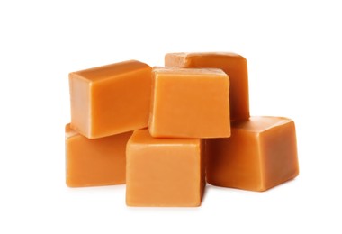 Many caramel cubes on white background. Confectionery