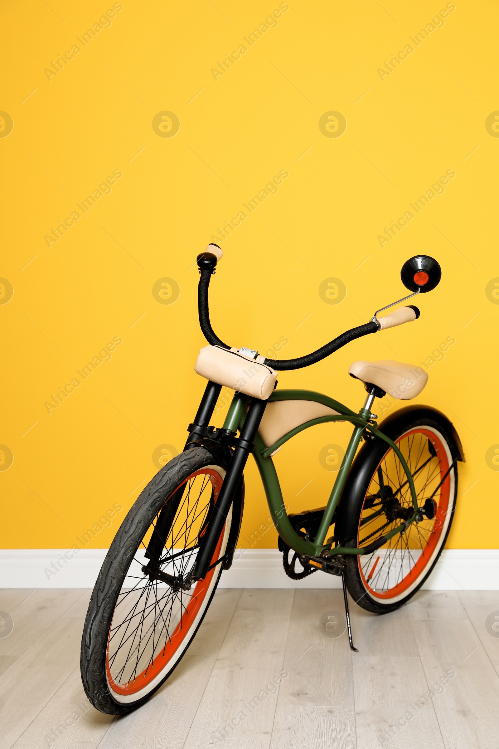 Photo of Stylish bicycle near color wall