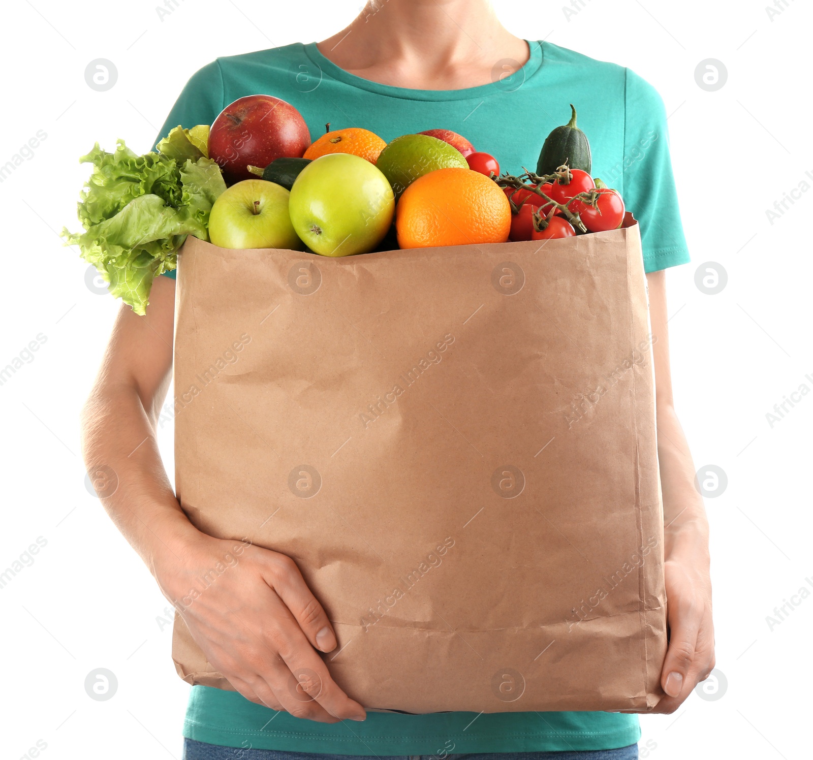 Photo of Woman holding paper bag with different groceries on white background, closeup view