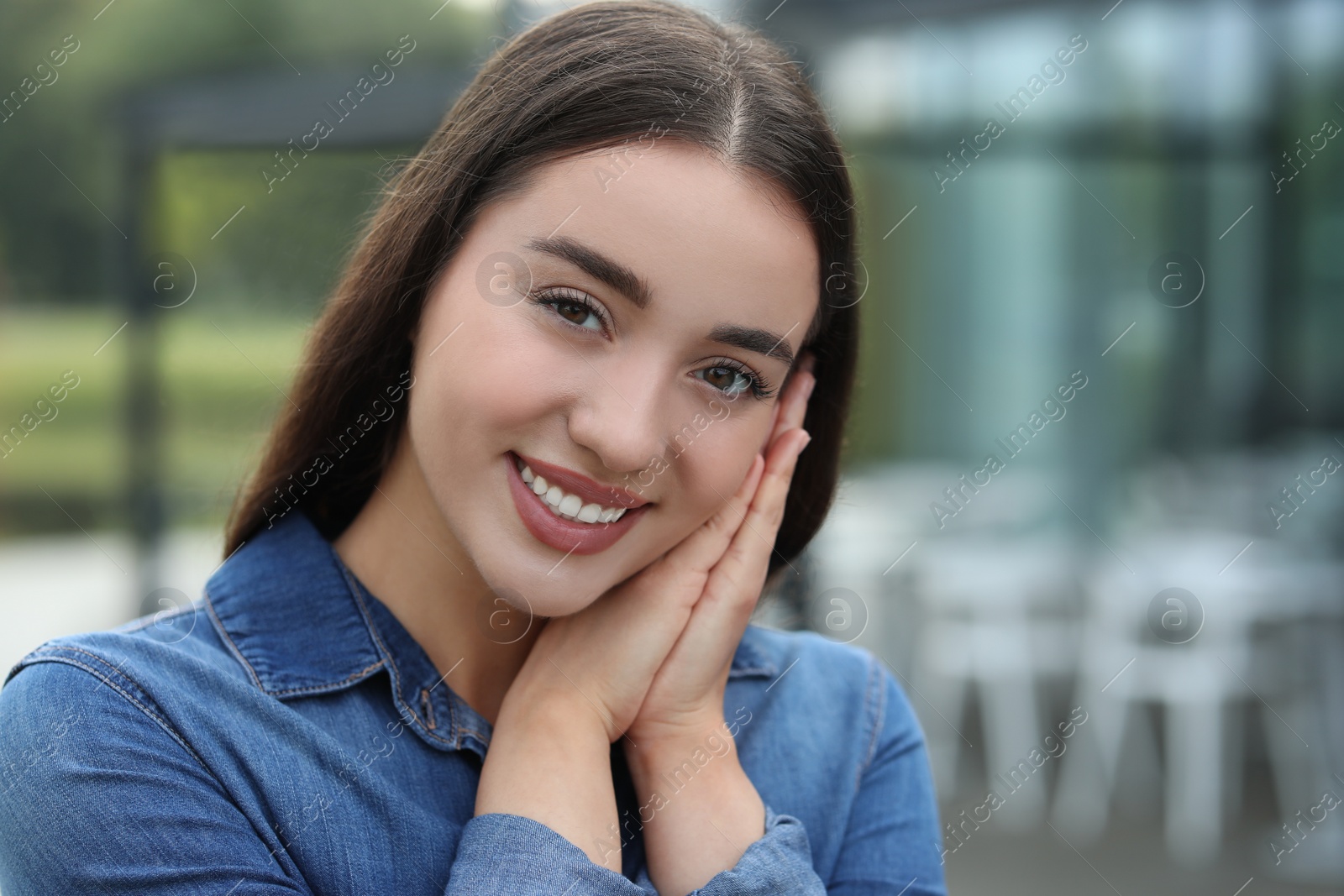 Photo of Portrait of beautiful woman outdoors. Attractive lady smiling and looking into camera. Space for text