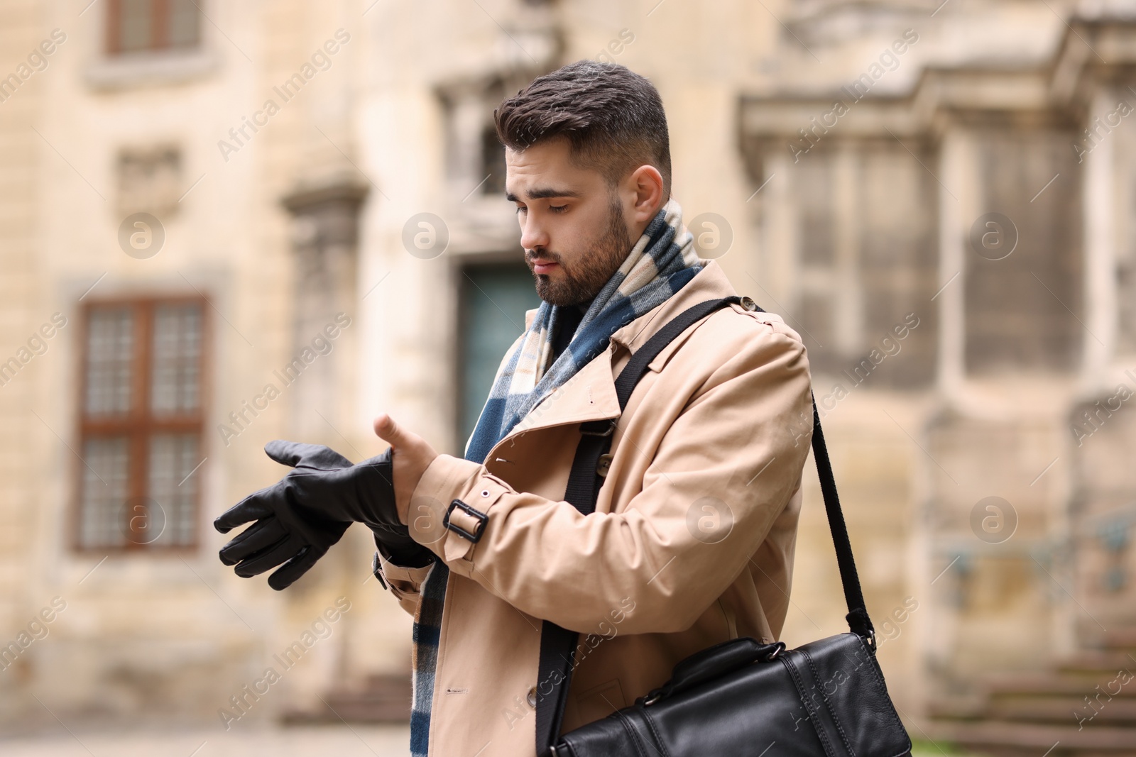 Photo of Handsome man in warm scarf on city street