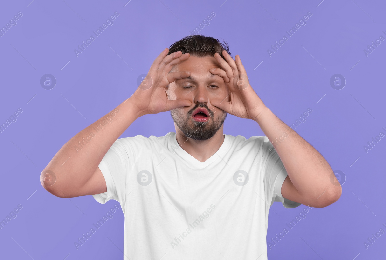 Photo of Sleepless man on violet background. Insomnia problem