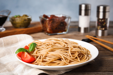 Photo of Tasty buckwheat noodles served on wooden table