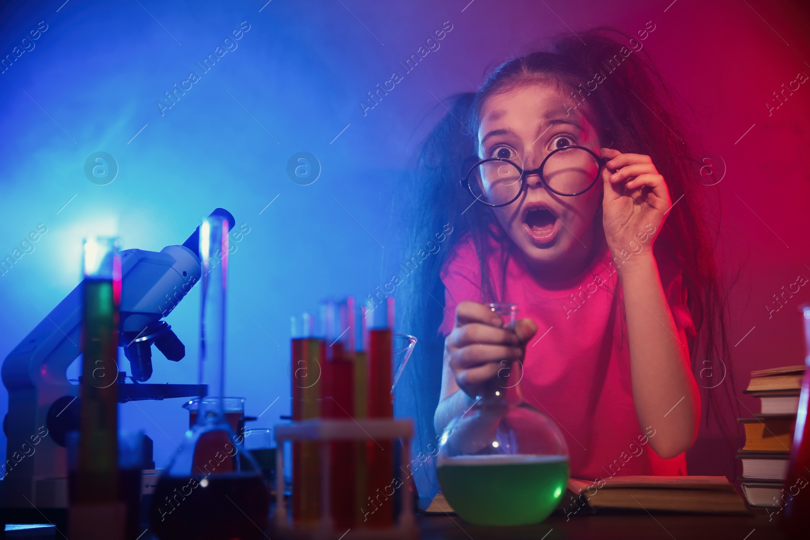 Photo of Child doing chemical research in laboratory. Dangerous experiment