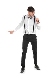 Photo of Handsome man in formal clothes singing with microphone on white background