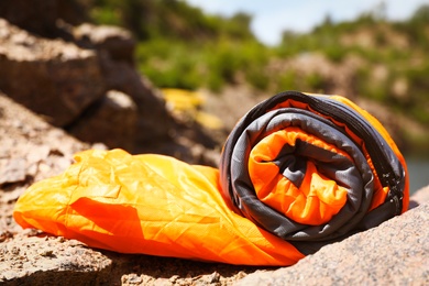 Rolled sleeping bag outdoors on sunny day