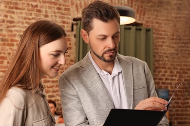 Photo of Team of employees working together in office