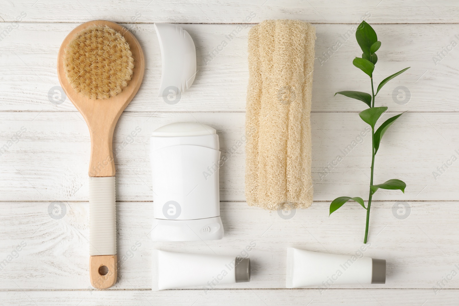 Photo of Flat lay composition with natural deodorant and bath accessories on white wooden table