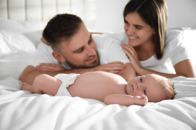 Happy couple with their newborn baby at home