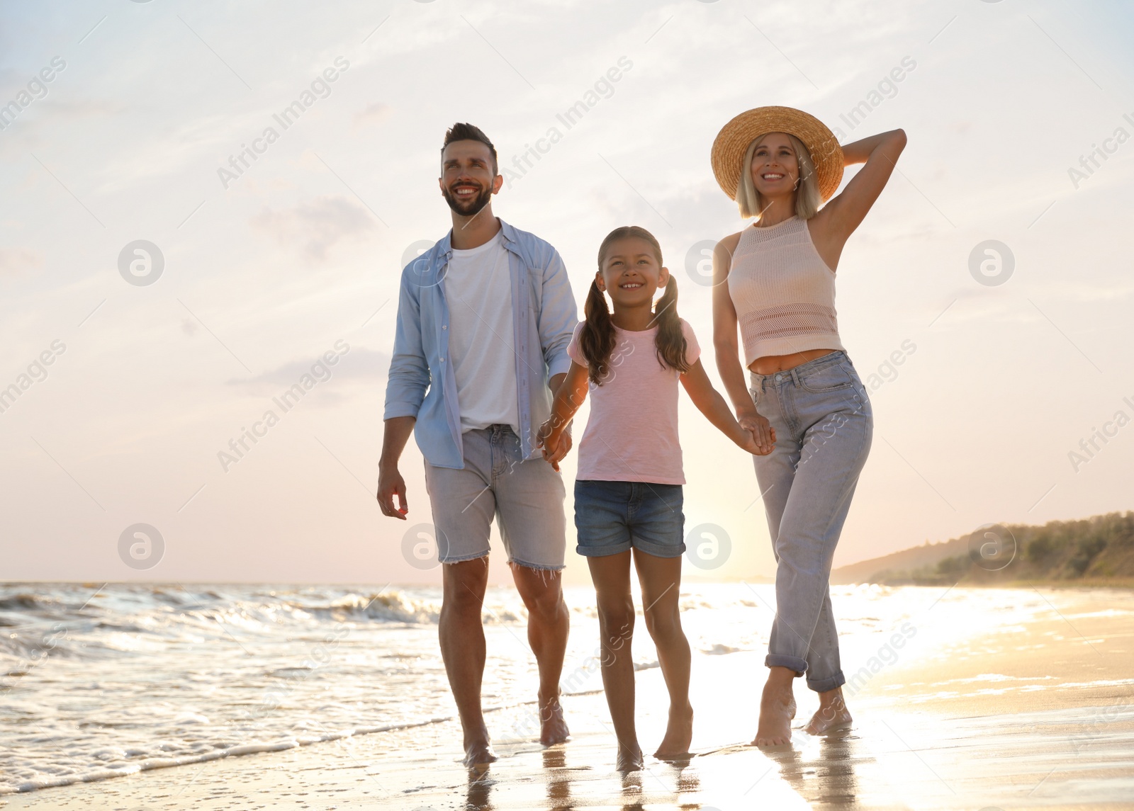 Photo of Happy family on sandy beach near sea