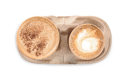 Photo of Takeaway paper cups with coffee in cardboard holder on white background, top view