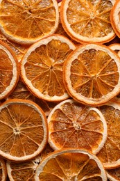 Heap of dry orange slices as background, top view