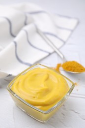 Photo of Tasty curry sauce and powder on white table