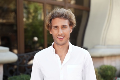 Portrait of handsome young man on city street