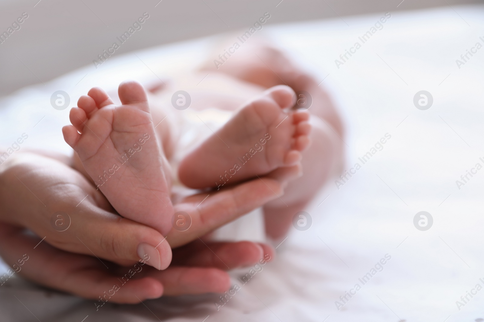 Photo of Mother and her newborn baby on bed, closeup