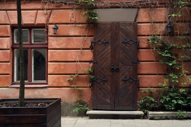 Photo of View of building with vintage wooden door and window. Exterior design