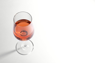 Photo of Glass of delicious wine on white background, above view