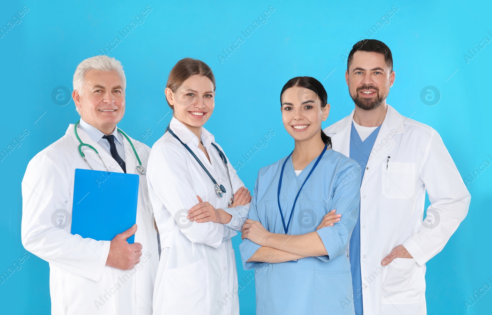 Photo of Group of doctors against blue background. Medical service