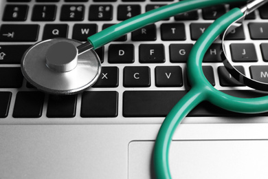 Photo of Stethoscope on laptop, closeup. Concept of technical support