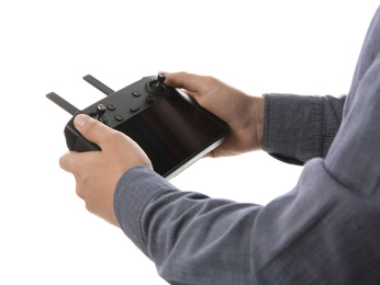 Man holding new modern drone controller on white background, closeup of hands