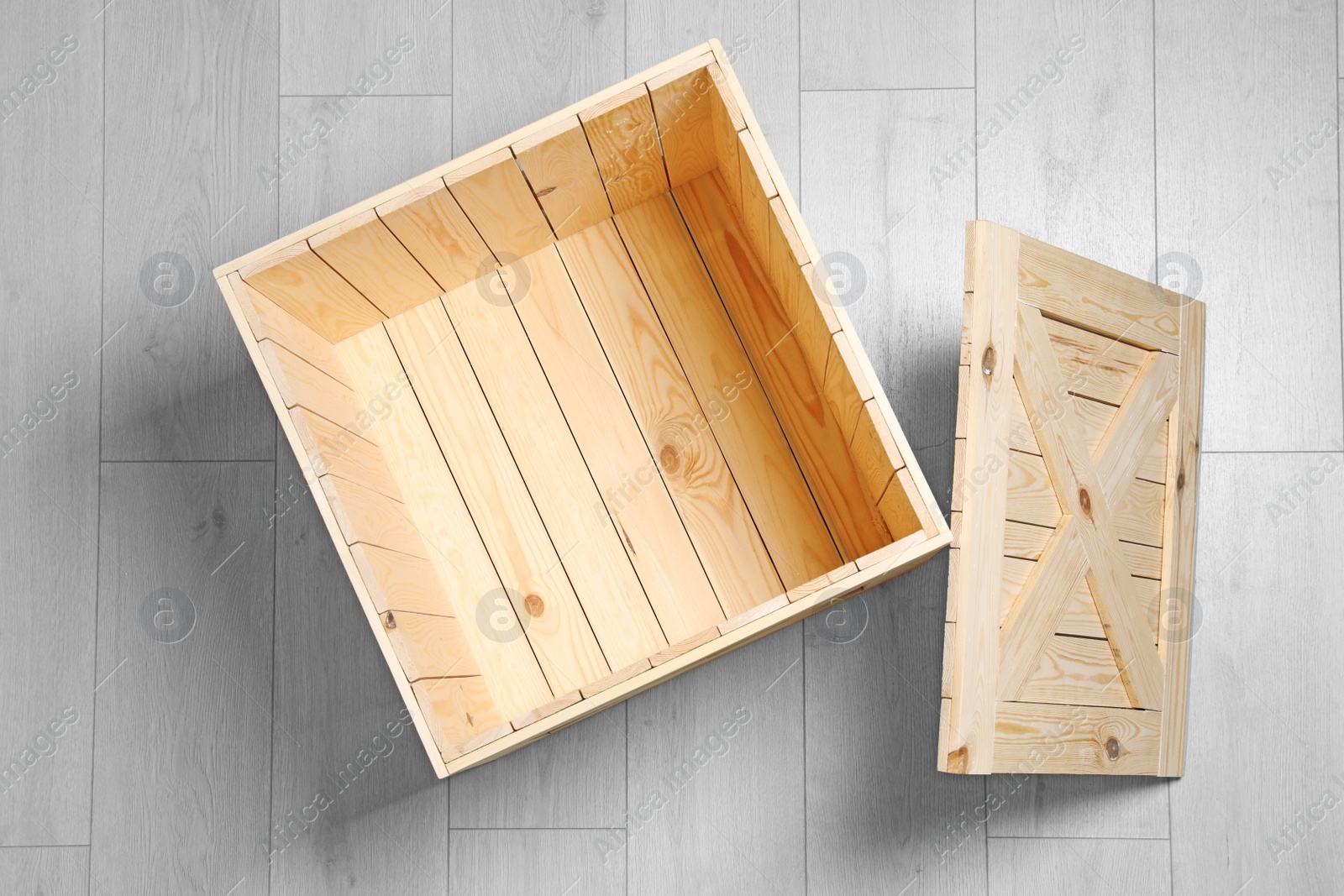 Photo of Open wooden crate on floor, top view