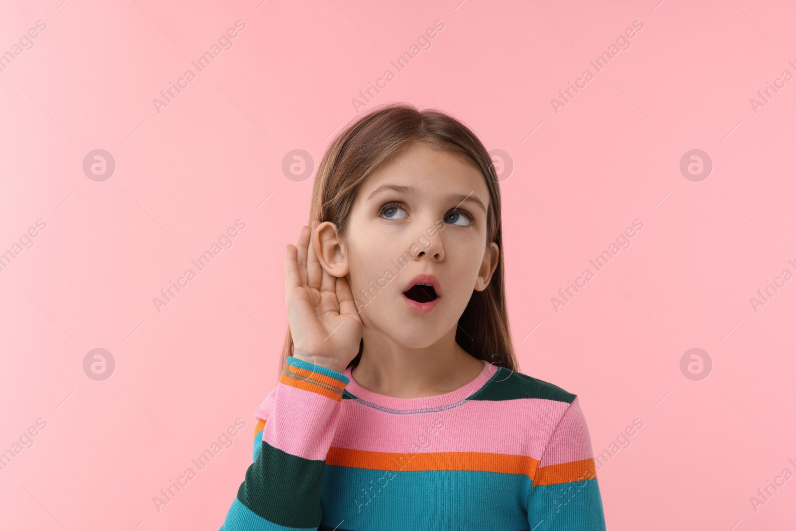 Photo of Little girl with hearing problem on pink background