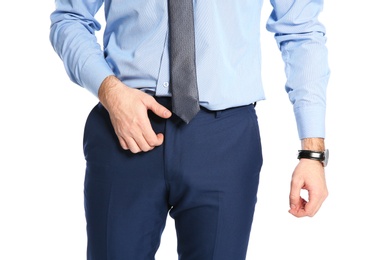 Man scratching crotch on white background, closeup. Annoying itch