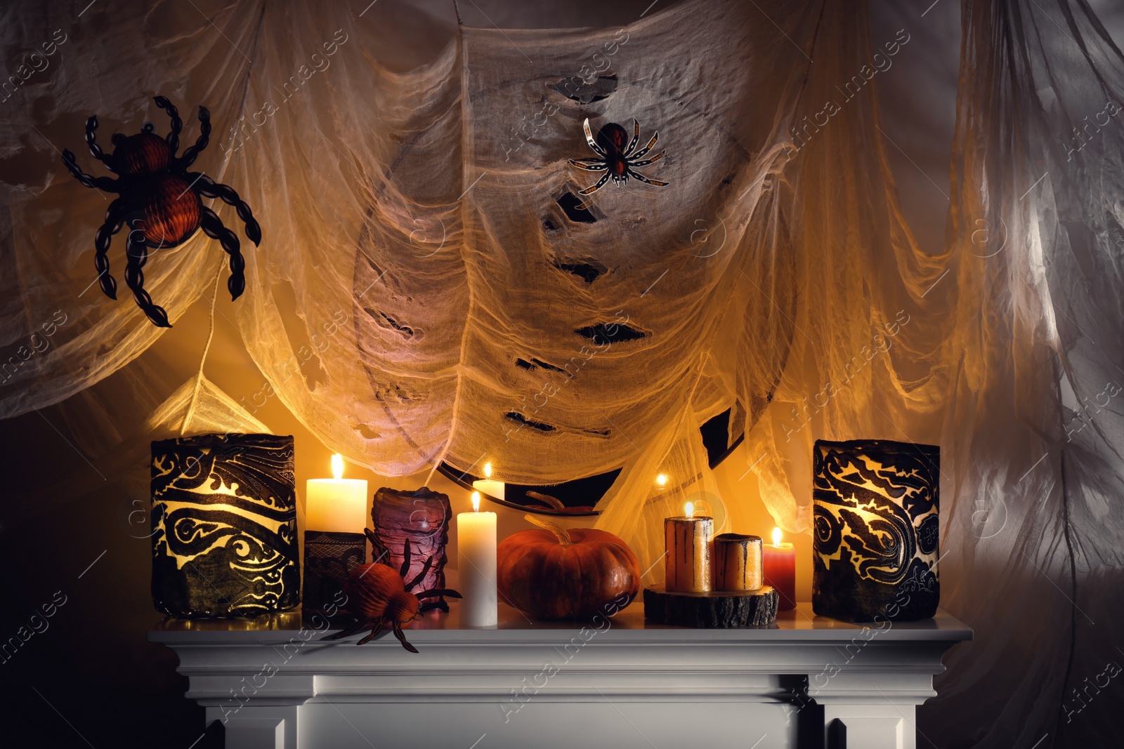 Photo of Different Halloween decor on fireplace indoors. Festive interior