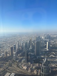 Dubai, United Arab Emirates - May 2, 2023: Picturesque view of city with skyscrapers from Burj Khalifa